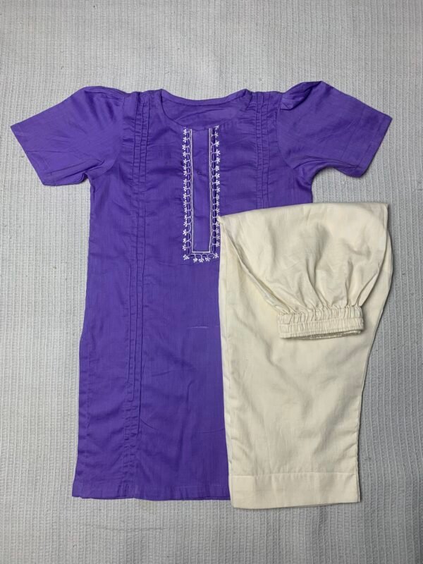 Flat lay of kids two-piece outfit featuring purple embroidered kurti with beige trousers – traditional girls clothing set